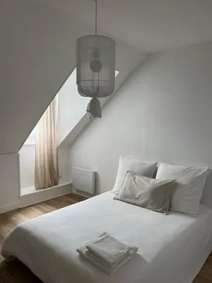 Un ou plusieurs lits dans un hébergement de l'établissement Le Petit Cottage - Appartement Centre-Ville & Plage