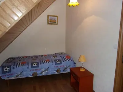 Un ou plusieurs lits dans un hébergement de l'établissement Villa spacieuse à Concarneau avec piscine privée