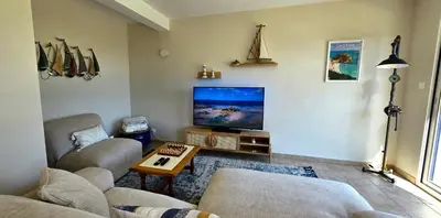 Télévision ou salle de divertissement dans l'établissement Maison vue mer Posto Home Crozon
