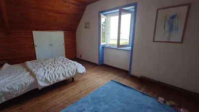 Un ou plusieurs lits dans un hébergement de l'établissement Jolie maison vue sur mer
