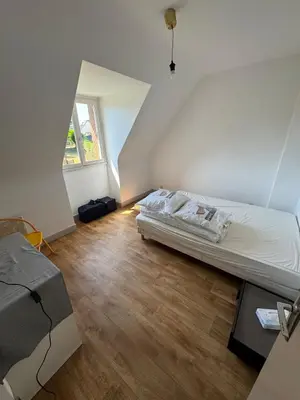 Un ou plusieurs lits dans un hébergement de l'établissement Maison trois chambres en impasse