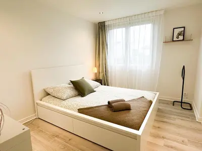 Un ou plusieurs lits dans un hébergement de l'établissement Appartement lumineux avec balcon Parking privé