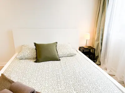 Un ou plusieurs lits dans un hébergement de l'établissement Appartement lumineux avec balcon Parking privé