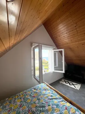 Un ou plusieurs lits dans un hébergement de l'établissement Maison en bord de mer
