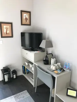 Télévision ou salle de divertissement dans l'établissement Un Moment à la Campagne