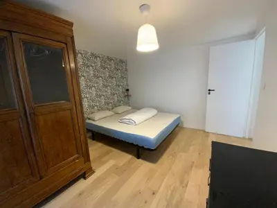 Un ou plusieurs lits dans un hébergement de l'établissement Appartement avec son jardin face au port d'Audierne