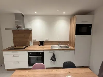 Cuisine ou kitchenette dans l'établissement Murmure de rose