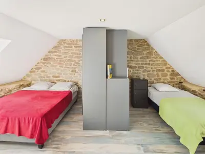 Un ou plusieurs lits dans un hébergement de l'établissement Charmante maison pour 6 à 900m de la plage