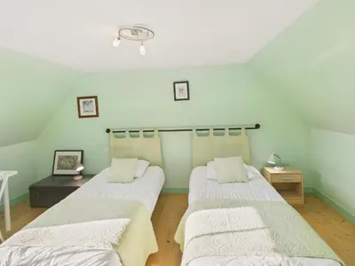 Un ou plusieurs lits dans un hébergement de l'établissement Gîte 6 personnes avec jardin proche plage