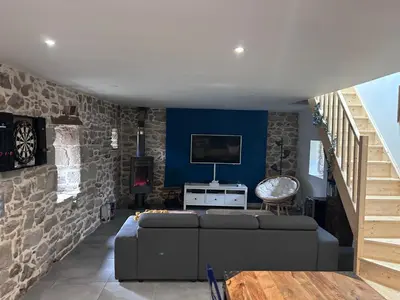Coin salon dans l'établissement Maison en pierre - ancien corps de ferme