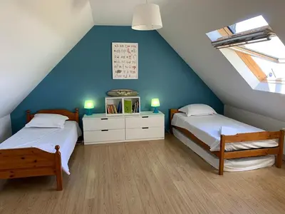 Un ou plusieurs lits dans un hébergement de l'établissement Maison bois proche plage de Goulien