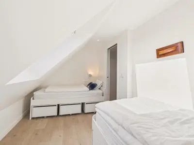 Un ou plusieurs lits dans un hébergement de l'établissement Plage à 300 m, maison pour 7, jardin et véranda
