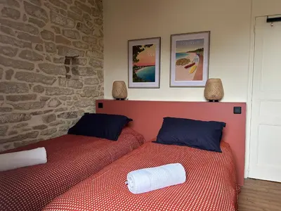 Un ou plusieurs lits dans un hébergement de l'établissement Le Cottage du Cap