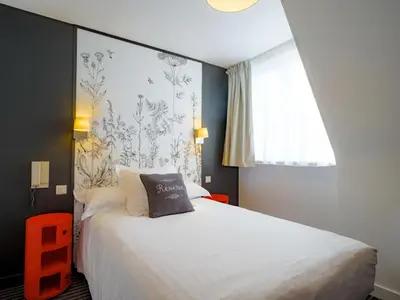 Un ou plusieurs lits dans un hébergement de l'établissement Hôtel La Résidence