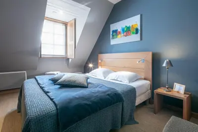Un ou plusieurs lits dans un hébergement de l'établissement La Vinotière Chambres Appartements Spa