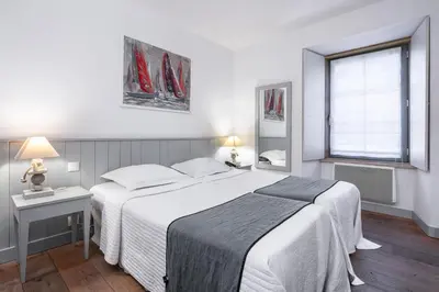 Un ou plusieurs lits dans un hébergement de l'établissement La Vinotière Chambres Appartements Spa