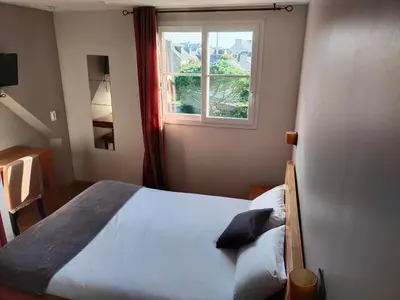 Un ou plusieurs lits dans un hébergement de l'établissement Hotel Au Bout Du Monde
