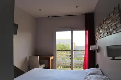 Un ou plusieurs lits dans un hébergement de l'établissement Hotel Au Bout Du Monde