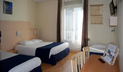 Un ou plusieurs lits dans un hébergement de l'établissement Le Bretagne - Hôtel
