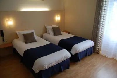 Un ou plusieurs lits dans un hébergement de l'établissement Le Bretagne - Hôtel
