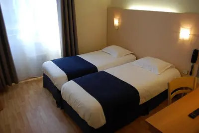 Un ou plusieurs lits dans un hébergement de l'établissement Le Bretagne - Hôtel