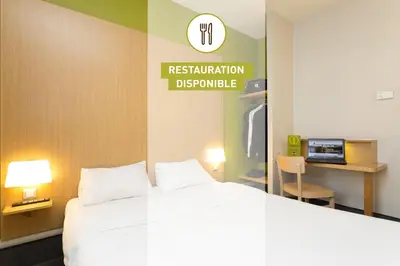 Un ou plusieurs lits dans un hébergement de l'établissement B&B HOTEL Quimper Nord Douarnenez