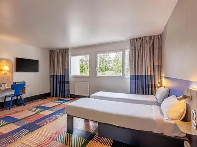 Un ou plusieurs lits dans un hébergement de l'établissement B&B HOTEL Brest Port du Moulin Blanc