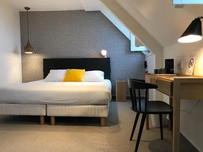 Un ou plusieurs lits dans un hébergement de l'établissement Hotel de France