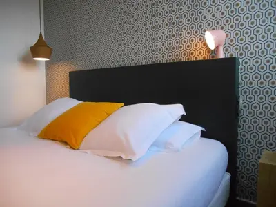Un ou plusieurs lits dans un hébergement de l'établissement Hotel de France