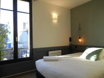 Un ou plusieurs lits dans un hébergement de l'établissement Hotel de France