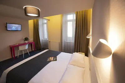 Un ou plusieurs lits dans un hébergement de l'établissement Hôtel Du Port