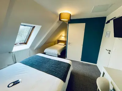 Un ou plusieurs lits dans un hébergement de l'établissement Hôtel Du Port