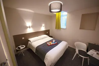 Un ou plusieurs lits dans un hébergement de l'établissement Hôtel Du Port