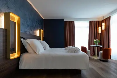 Un ou plusieurs lits dans un hébergement de l'établissement Hôtel & Spa Oceania Le Conti