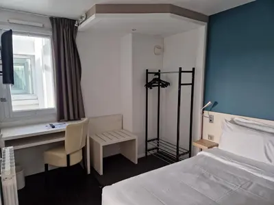 Un ou plusieurs lits dans un hébergement de l'établissement Kyriad Quimper Sud