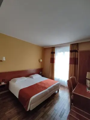 Un ou plusieurs lits dans un hébergement de l'établissement Hôtel Vauban