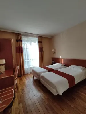 Un ou plusieurs lits dans un hébergement de l'établissement Hôtel Vauban
