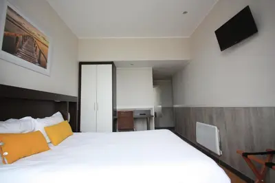 Un ou plusieurs lits dans un hébergement de l'établissement Hotel De La Rade