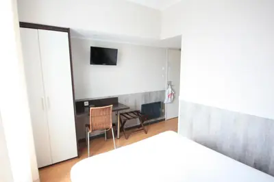 Un ou plusieurs lits dans un hébergement de l'établissement Hotel De La Rade