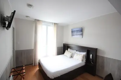 Un ou plusieurs lits dans un hébergement de l'établissement Hotel De La Rade