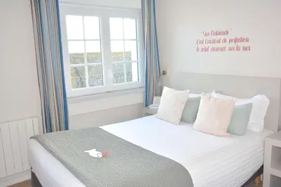 Un ou plusieurs lits dans un hébergement de l'établissement Hotel du Centre - Chez Janie
