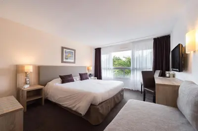 Un ou plusieurs lits dans un hébergement de l'établissement Brit Hôtel De L'océan