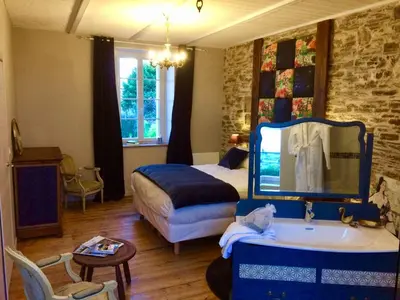 Un ou plusieurs lits dans un hébergement de l'établissement Les Chambres du Mad