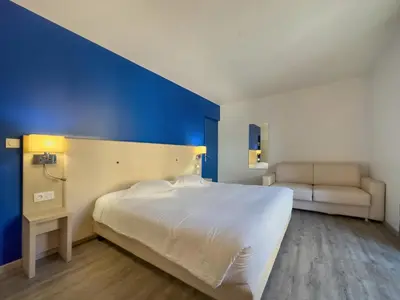 Un ou plusieurs lits dans un hébergement de l'établissement Hotel De La Gare