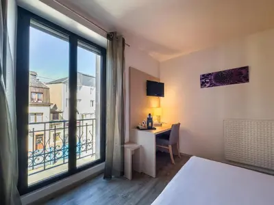 Un ou plusieurs lits dans un hébergement de l'établissement Hotel De La Gare
