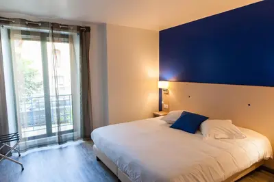 Un ou plusieurs lits dans un hébergement de l'établissement Hotel De La Gare