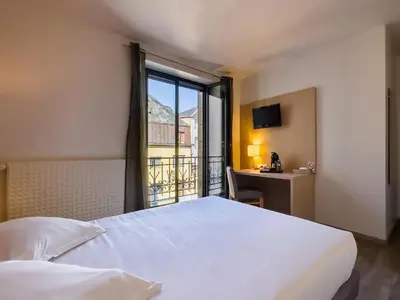 Un ou plusieurs lits dans un hébergement de l'établissement Hotel De La Gare