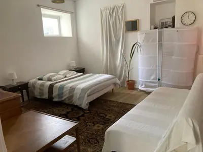 Un ou plusieurs lits dans un hébergement de l'établissement Grand Studio Type Loft