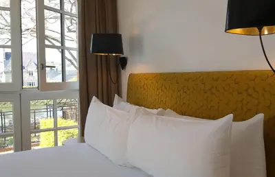 Un ou plusieurs lits dans un hébergement de l'établissement Hôtel Ginkgo - SPA Biloba