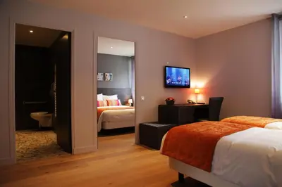 Un ou plusieurs lits dans un hébergement de l'établissement Cozy hôtel logis Morlaix